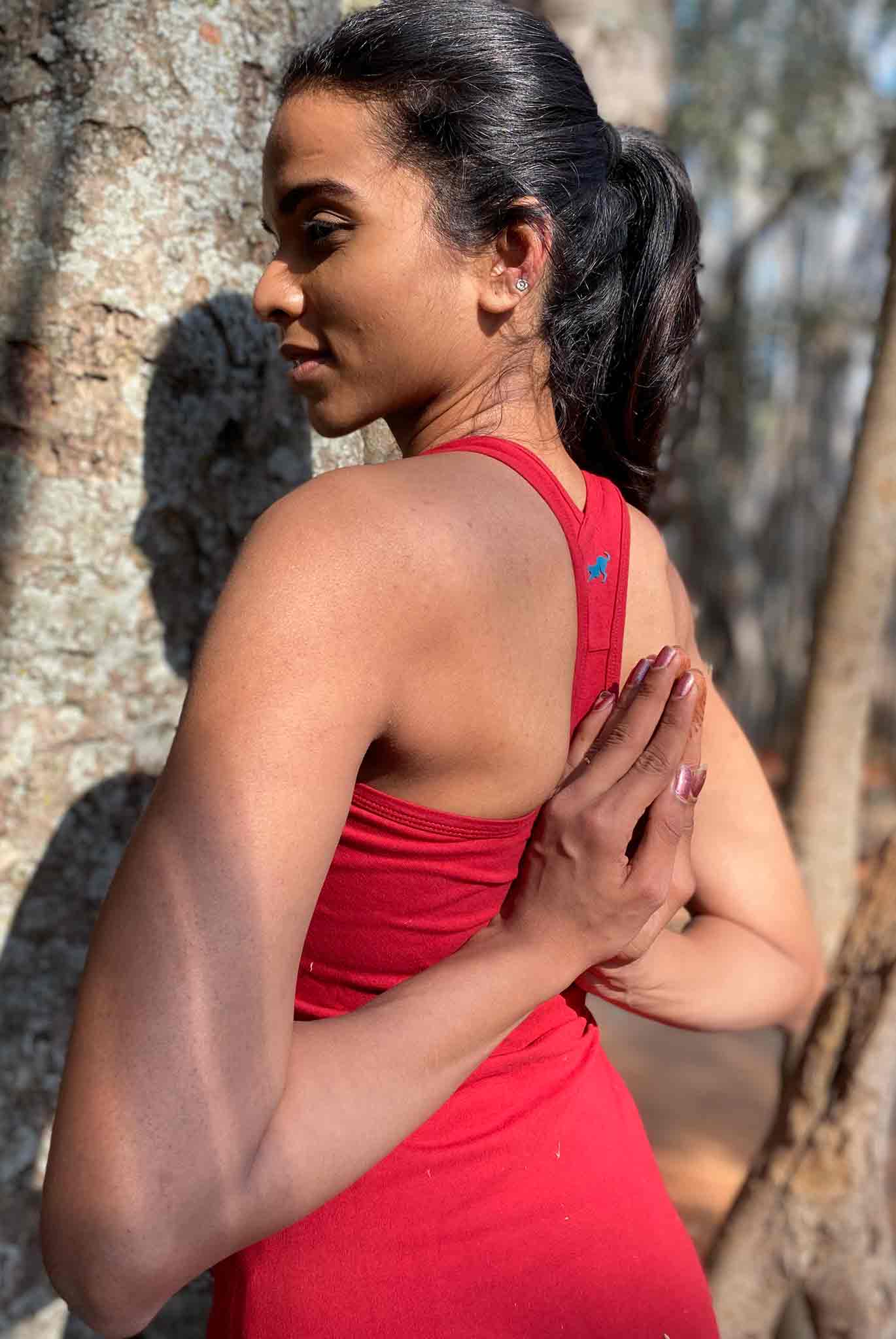 Girl in a Red Yoga Racerback Tank Top with back detail shown