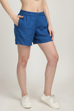 Girl in 100% linen blue shorts with pocket side view