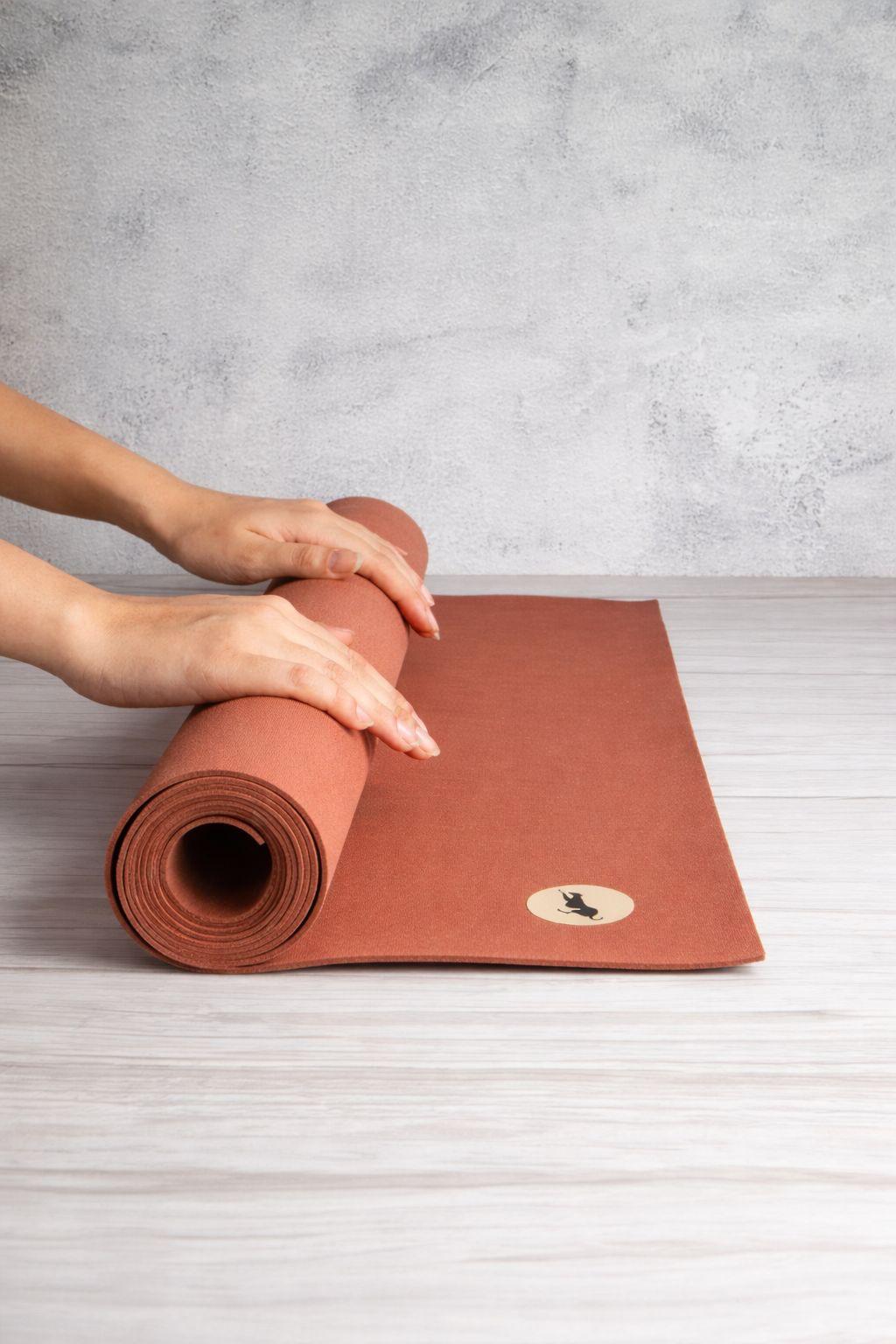 Kochi Mat rolled up for travel, a lightweight natural rubber yoga mat