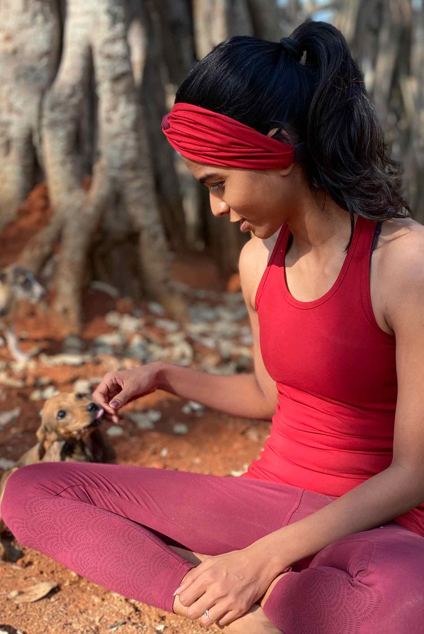 Girl in a Red Yoga Racerback Tank Top sitting with a puppy