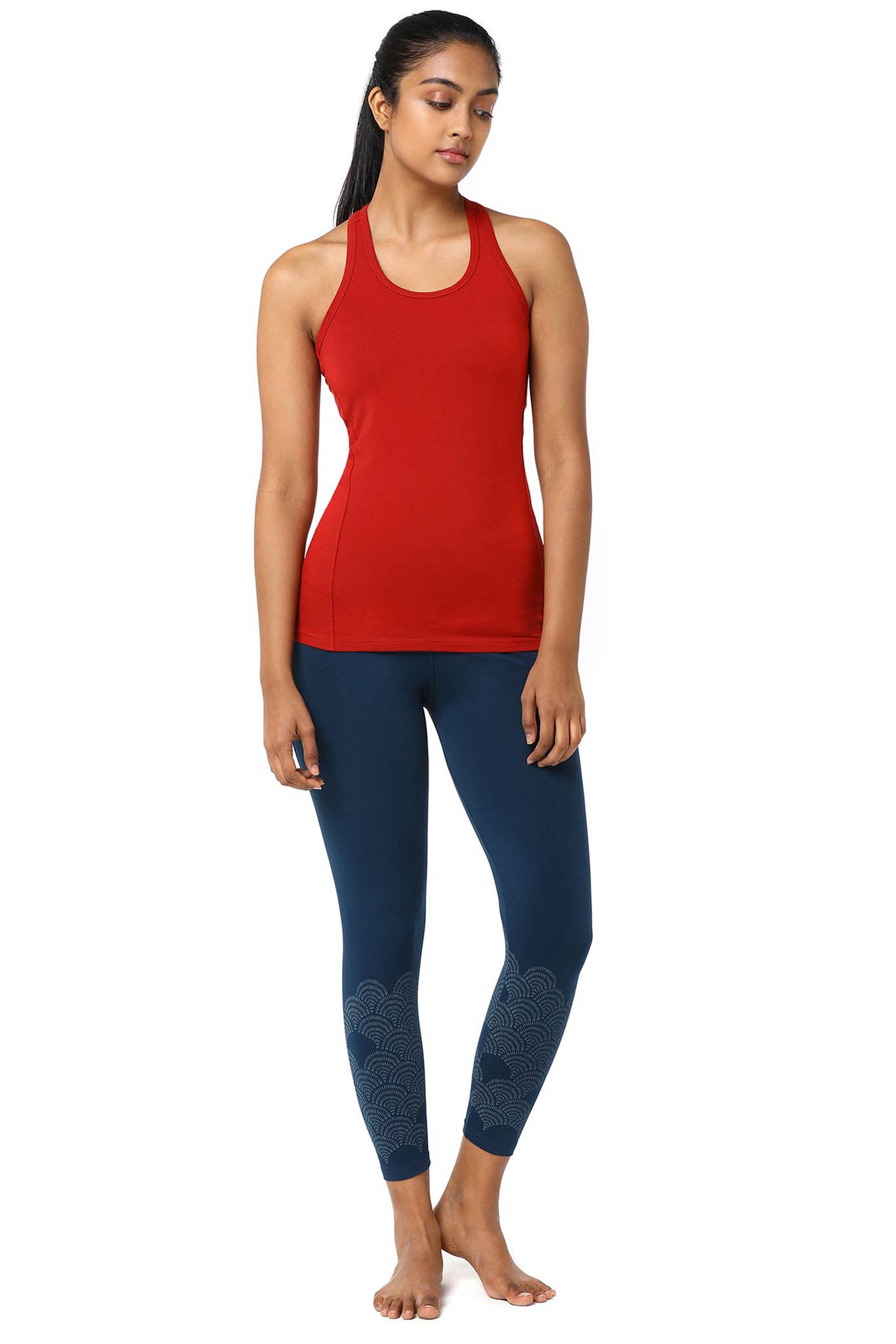 Yoga Racerback Fitted Tank. Look with Leggings.Girl in a Red Yoga Racerback Tank Top and Blue Yoga Leggings